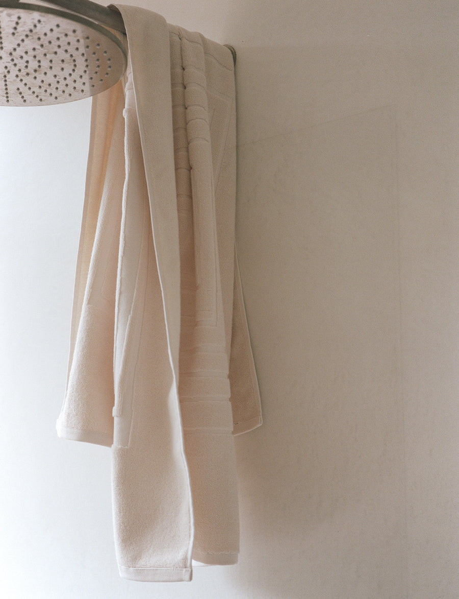 alt="Detailed view of Laze Res bath towel's signature embossed finish on organic cotton fabric"