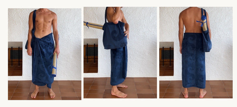 alt=“Person draped in Laguna Towel by Laze Res x Journal 1992, highlighting deep blue hue and textured design”